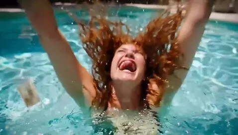AI Video from prompt: a woman diving into a pool full of money