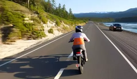 AI Video from prompt: a starfish riding a bike on a highway in alaska