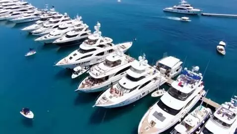 AI Video from prompt: A cluster of yachts gather in a blue lagoon with