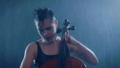 The gorgeous  woman plays her cello, fiercely, p