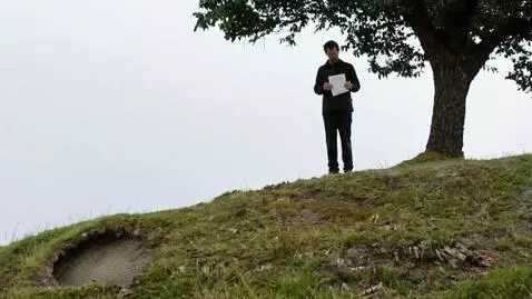 AI Video from prompt: a man reads a letter under a tree on top of a hi