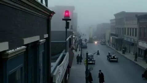 AI Video from prompt: “A 1940s downtown street freezes as an air raid 