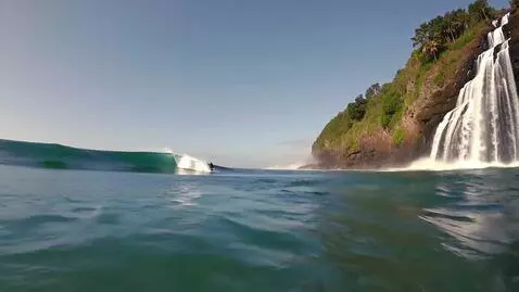 AI Video from prompt: a surfer surfs down a waterfall into the ocean a