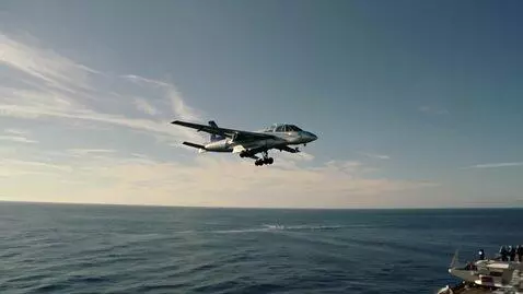 AI Video from prompt: A fighter jet landing on a airplane carrier in t