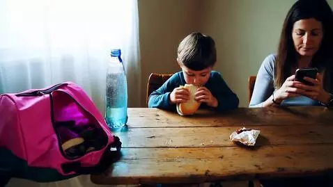 AI Video from prompt: Little boy sitting at a table eating a sandwich.