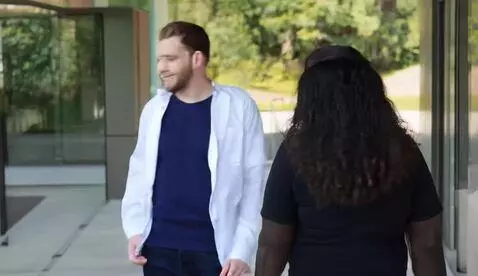 AI Video from prompt: Guy walking round with a Huge.com t-shirt and wo