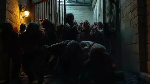 AI Video from prompt: a big group of zombies are locked up behind a me