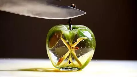 AI Video from prompt: Нож нарезает стеклянное прозрачное яблоко