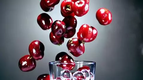 AI Video from prompt: Ultra-realistic macro shot, frozen cherries fall
