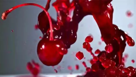 AI Video from prompt: Close-up of thick grenadine syrup mixing with ch