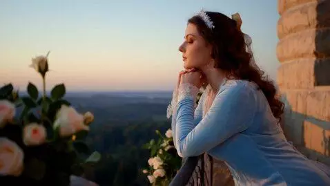 AI Video from prompt: On the castle balcony at dawn, a princess in pal