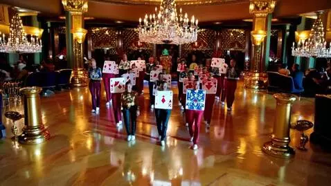 AI Video from prompt: Playing cards marching in a gold casino