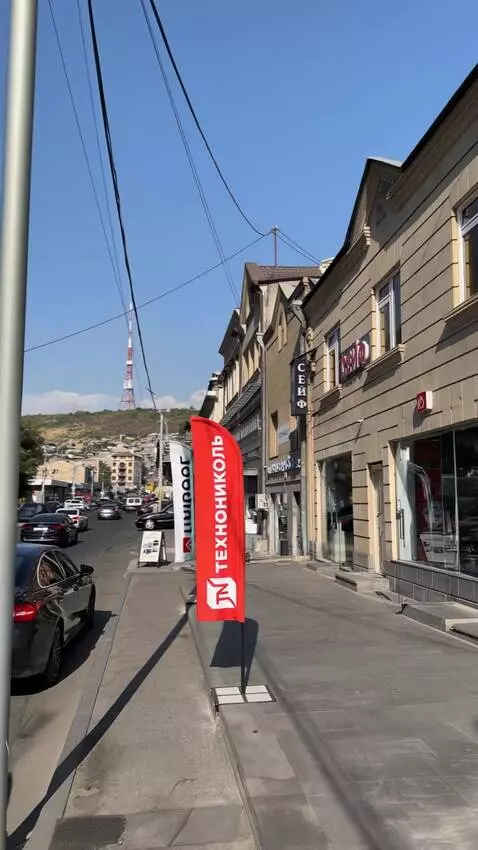 AI Video from prompt: Cinematic zoom-out from a sunny urban street wit