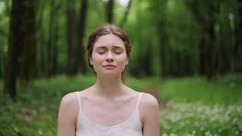 AI Video from prompt: A young white woman sits cross-legged in a quiet