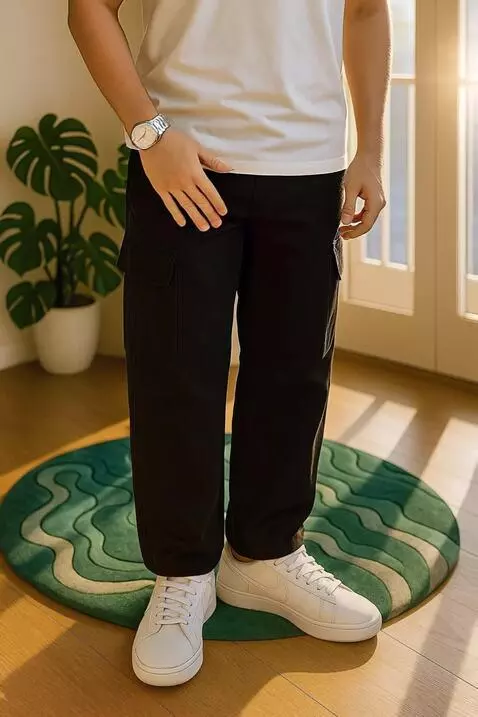 AI Video from prompt: A young man models black cargo pants and white s