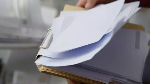 AI Video from prompt: a folder of documents with clean white sheets is