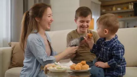 AI Video from prompt: Baby is eating his dog’s tale and his brother la