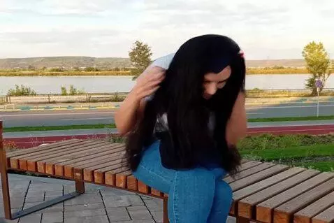 AI Video from prompt: woman puts on graduation cap and gown
