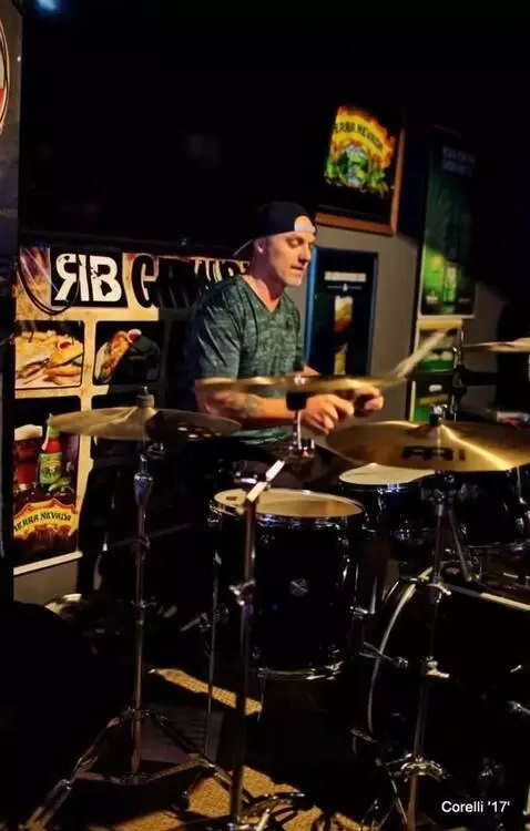 AI Video from prompt: Make the drummer play the drum set, with fancy d