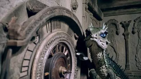 AI Video from prompt: A basilisk with crystal eyelids pushes the hand 