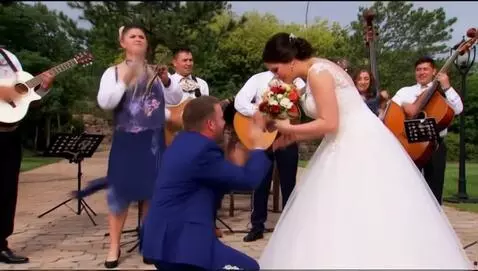 AI Video from prompt: mariachi band sereneding a couple during a propo
