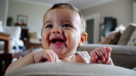 AI Video from prompt: A baby laughing at the father's coaxing voice
