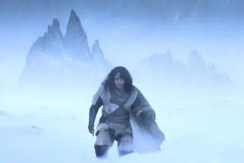 AI Video from prompt: The camera cuts to a lone figure trudging throug