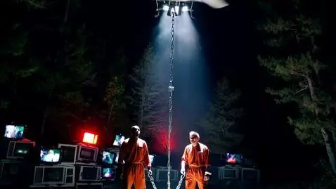 AI Video from prompt: a nighttime POV shot from a helicopter looking d
