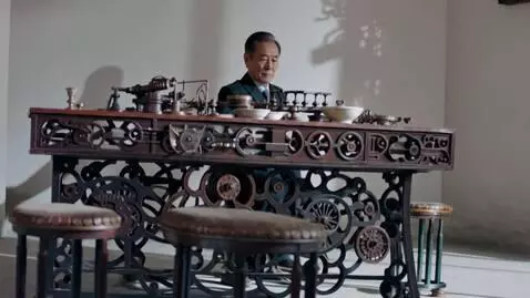 AI Video from prompt: The whole table is in gears. The old man inserts