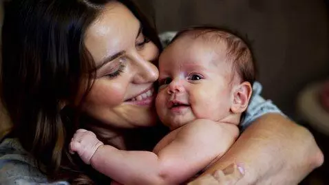 AI Video from prompt: A Mother cradling her baby Girl with love and ad