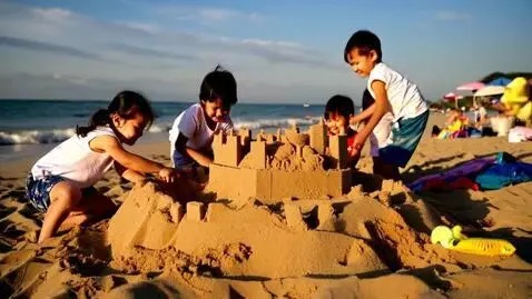 AI Video from prompt: Children making sand castle at the beach
