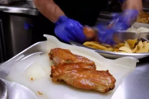 AI Video from prompt: Fowls preparing and serving chicken, chips and r