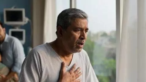 AI Video from prompt: The man takes slow, difficult breaths as the cur