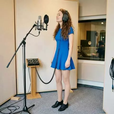 AI Video from prompt: A woman with headphones is singing. The camera r
