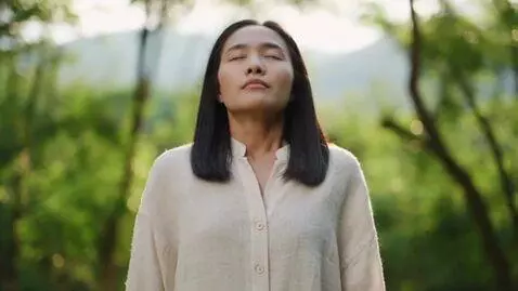 AI Video from prompt: Asian woman’s chest inflates slowly