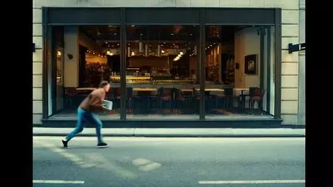 AI Video from prompt: A man in a brown sweatshirt, blue jeans, and bla