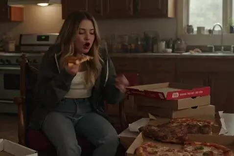 AI Video from prompt: A thin lazy girl steadily stuffing her face with