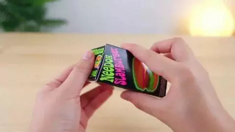AI Video from prompt: make a video of needoh slamburger unboxing asmr