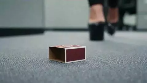 AI Video from prompt: A tiny little man, shut inside a matchbox, is ha