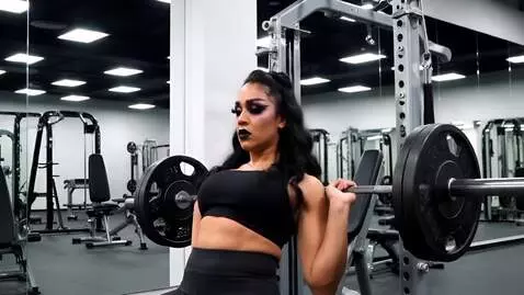 AI Video from prompt: Goth woman bench pressing weights