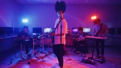 AI Video from prompt: Make that person stand up and do rock band