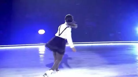 AI Video from prompt: A figure skater in a short tutu skirt performs a