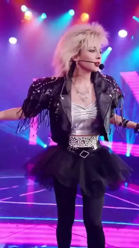 AI Video from prompt: A girl in a short tutu skirt is singing, pirouet