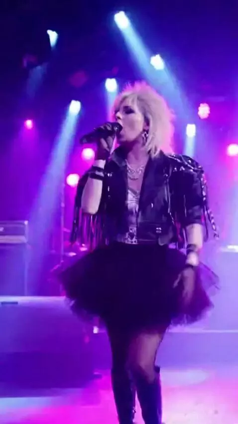 AI Video from prompt: A girl in a short tutu skirt is singing on stage