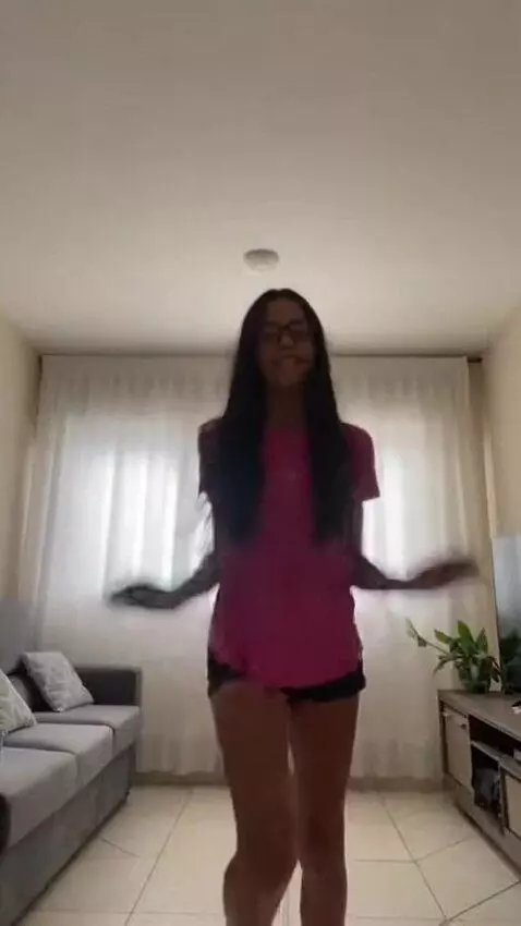 AI Video from prompt: A skinny brazilian girl, mid 10s  pink t-shirt t