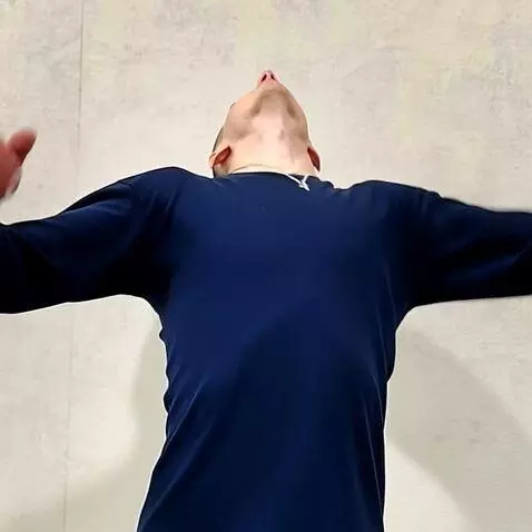 AI Video from prompt: The man arches his back sharply and rapidly—almo