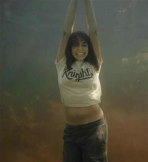 AI Video from prompt: A joyful woman with a thick, fit body dances wit