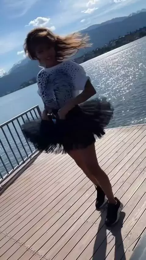 AI Video from prompt: A girl in a short tutu skirt turns around, does 
