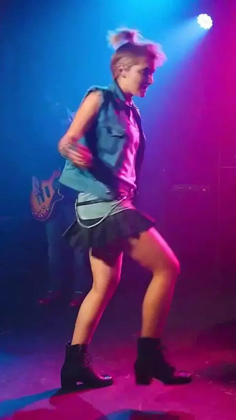 AI Video from prompt: A girl in a mini skirt is singing and spinning a
