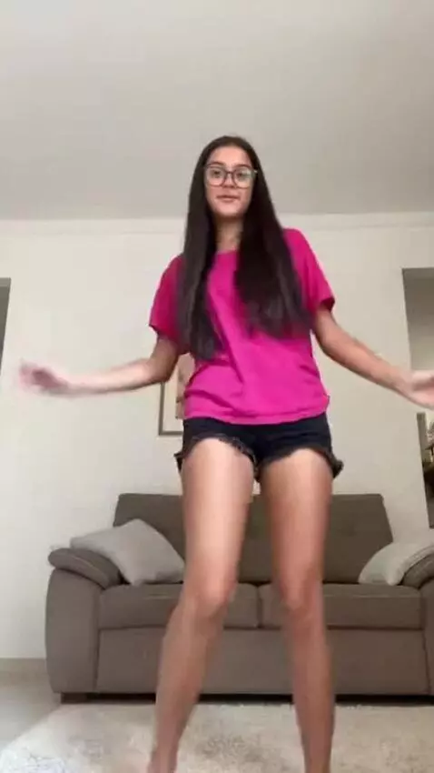 AI Video from prompt: A skinny brazilian girl, 17 yo, pink t-shirt tha